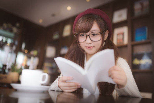 カフェで読書をするメガネ女子